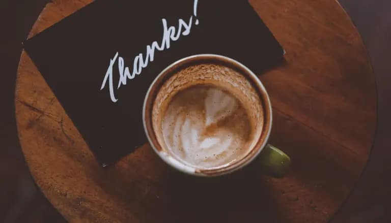 flat lay photography of coffee latte in teacup on table
