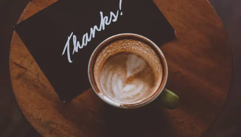 flat lay photography of coffee latte in teacup on table