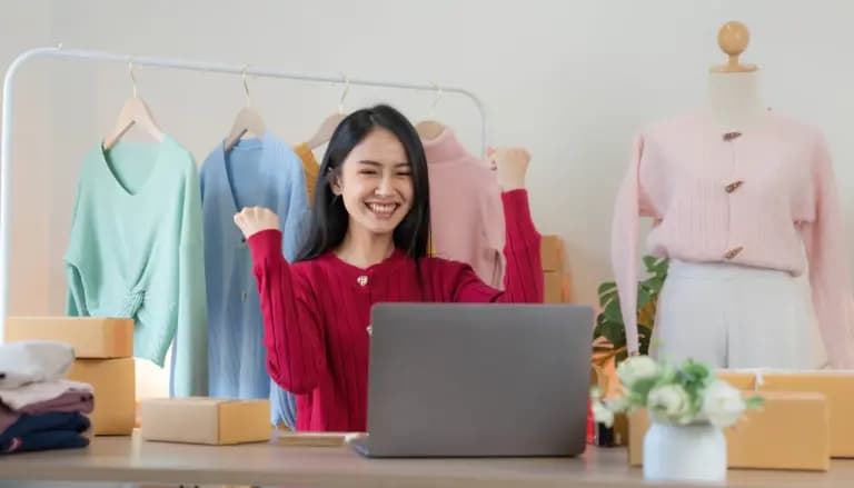 Woman analyzing sales strategies for her WooCommerce online shop at a desk with a laptop.