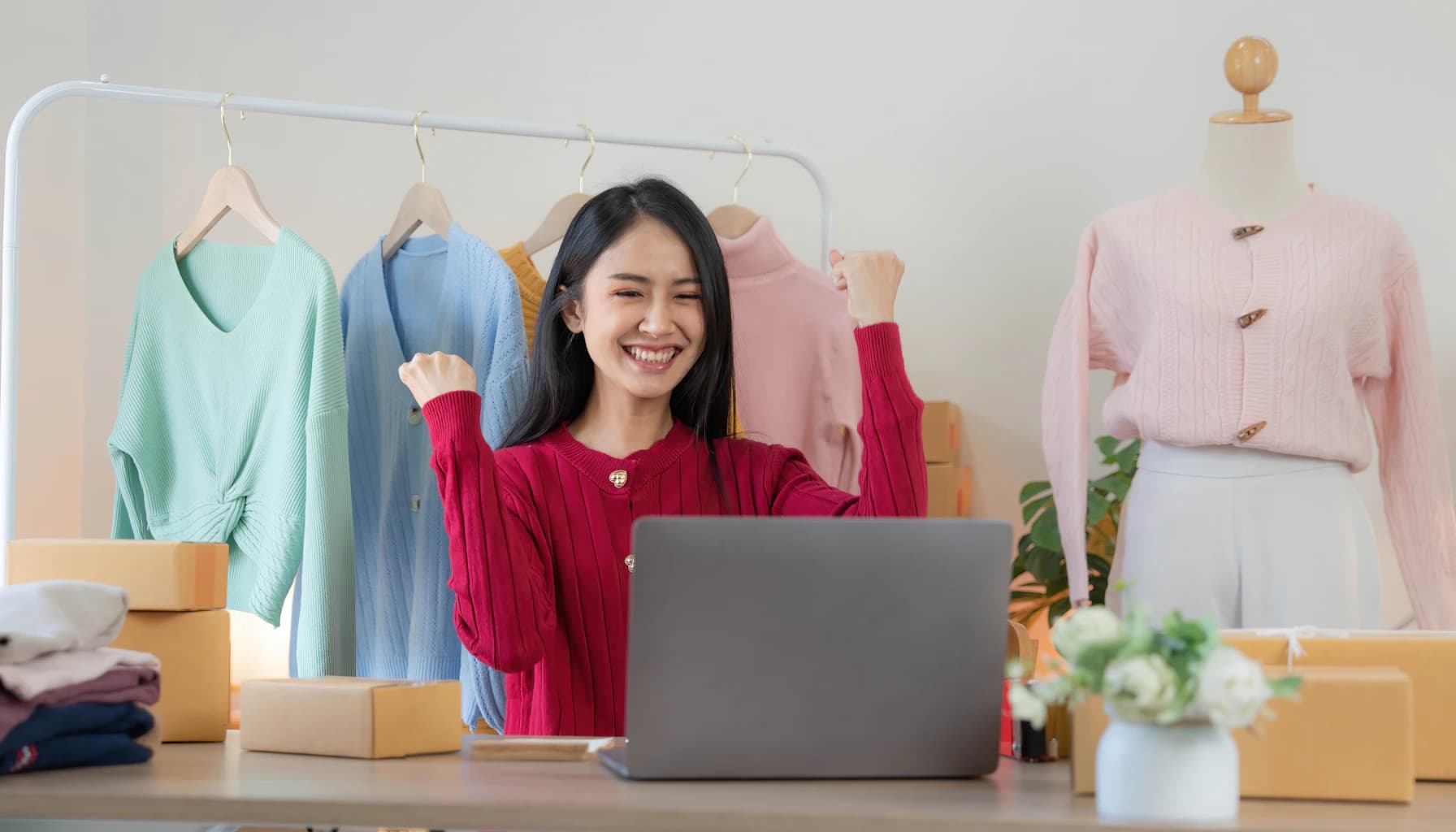 Woman analyzing sales strategies for her WooCommerce online shop at a desk with a laptop.